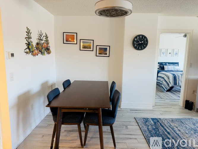 A dining room with a wooden table and chairs.