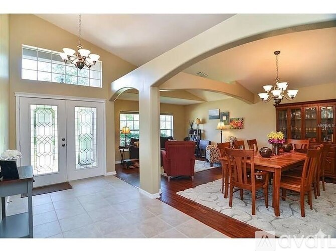 A dining room with a wooden table and chairs.