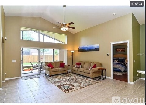 A living room with a couch and a rug in the middle.