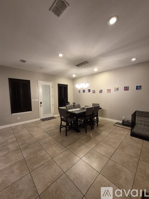 A dining room with a table and chairs.