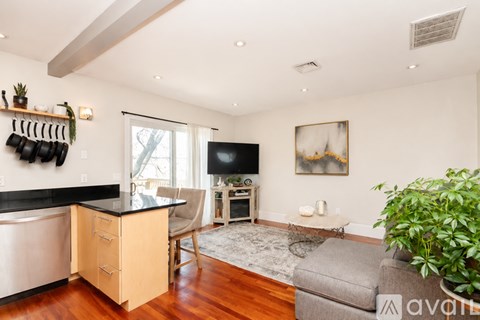 A living room with a grey couch and a television.