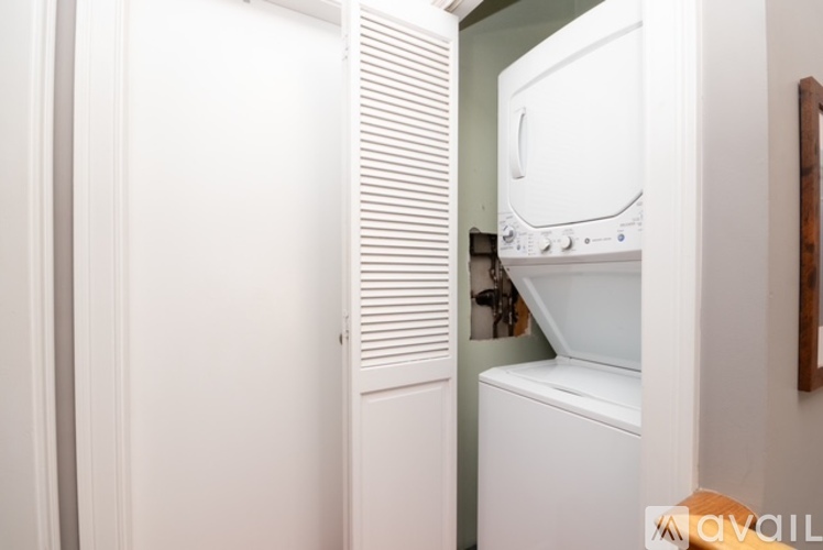 A white oven and microwave are installed in a kitchen.