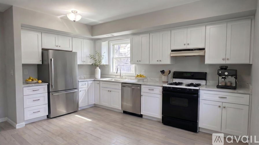 A kitchen with white cabinets and stainless steel appliances.