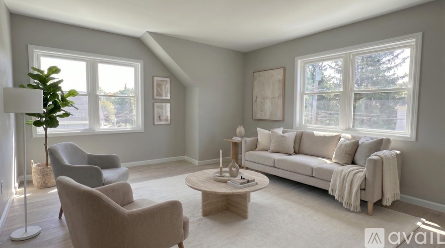 A living room with a grey couch, a wooden coffee table, and a floor lamp.