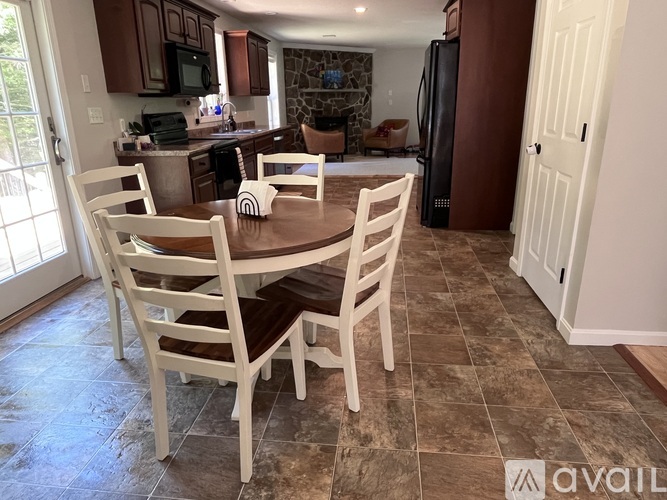 A kitchen with a table and chairs in the middle of the room.