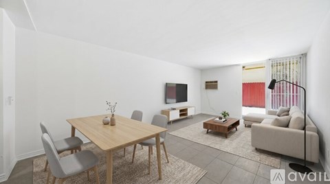A living room with a wooden table and grey chairs.