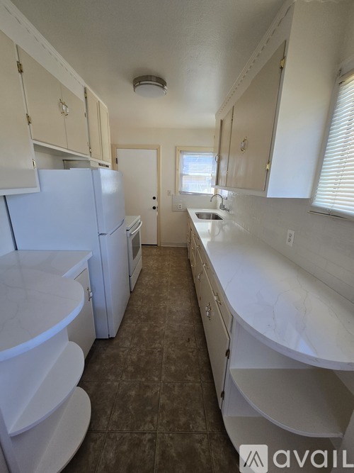 A bathroom with a toilet, sink, and bathtub.