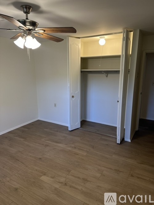 A room with a ceiling fan and light fixture.