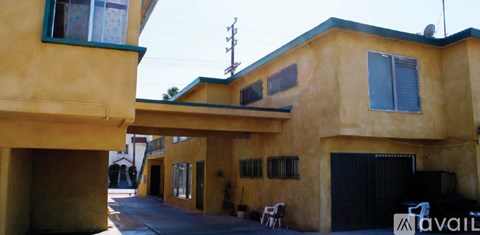 A yellow house with a black garage door.
