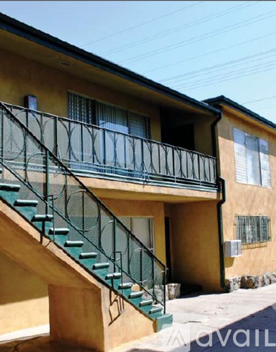 A yellow building with a green staircase.