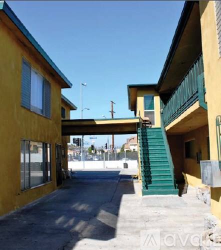 A yellow building with a green staircase.