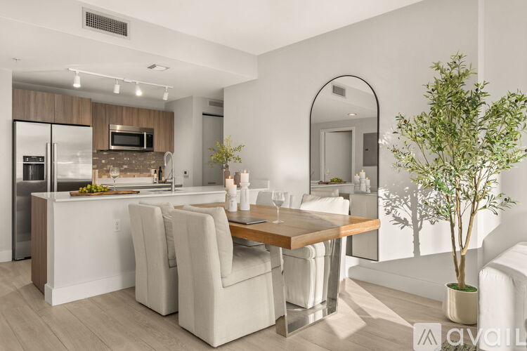 A modern kitchen with a dining table and chairs.