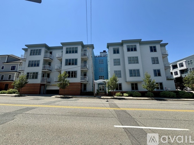 A row of apartment buildings with a clear blue sky above.