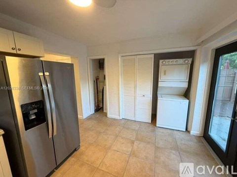A kitchen with a stainless steel refrigerator and a white fridge freezer.