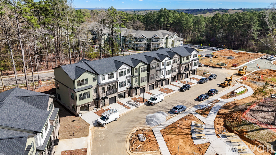 A bird's eye view of a construction site with a building in the background.