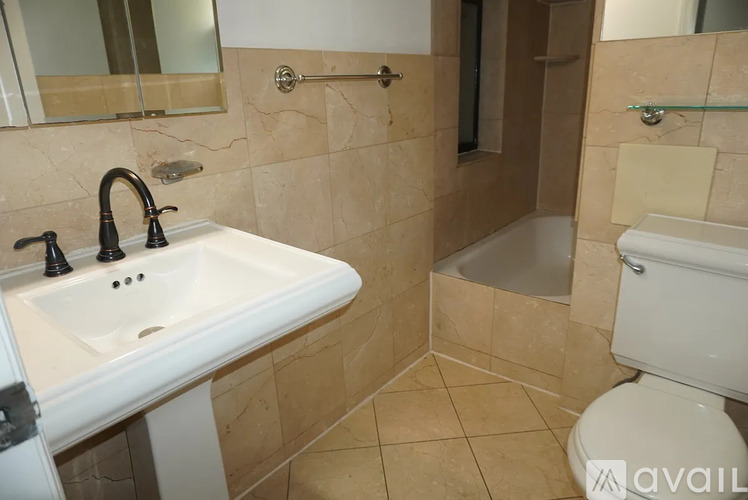 A bathroom with a sink, toilet, and bathtub.