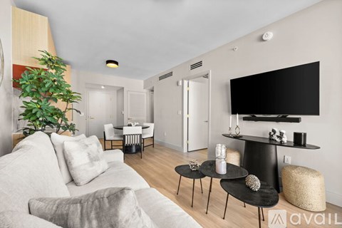 A living room with a grey couch and a black table.