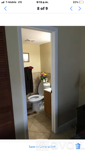 A white toilet is in a small bathroom.