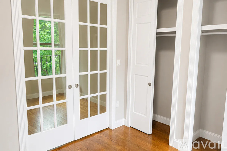 A white door with glass panels is open.