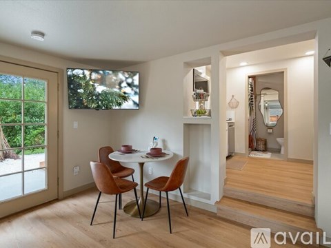 A dining area with a table and chairs is available for rent.