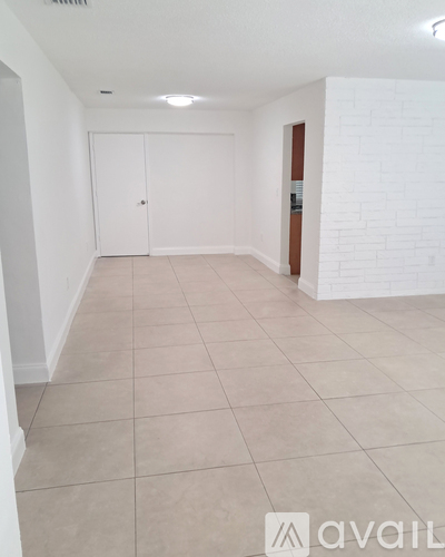 A room with white walls and a white tile floor.