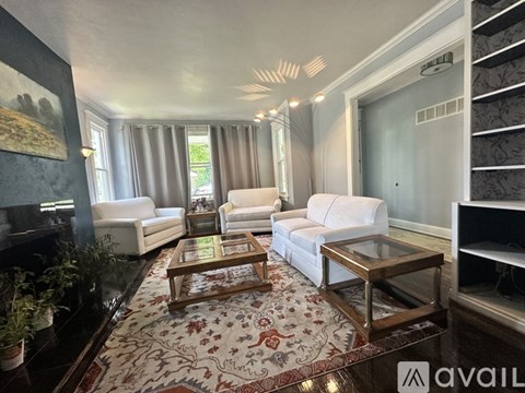 A living room with a rug and a coffee table.
