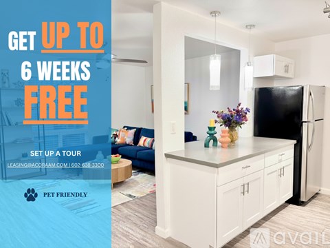 A modern kitchen with a black fridge and white cabinets is on offer for a 6 week free lease.