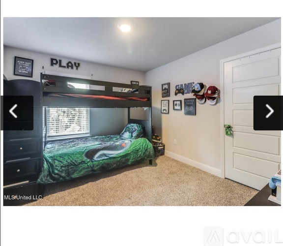 A bedroom with a bunk bed and a wall with pictures and decorations.