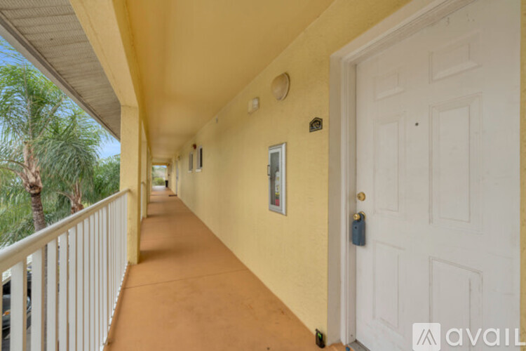 A long hallway with a white door at the end.