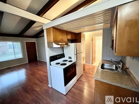 A kitchen with a stove and sink.