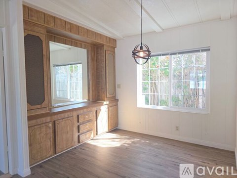 A room with wooden cabinets and a large window.