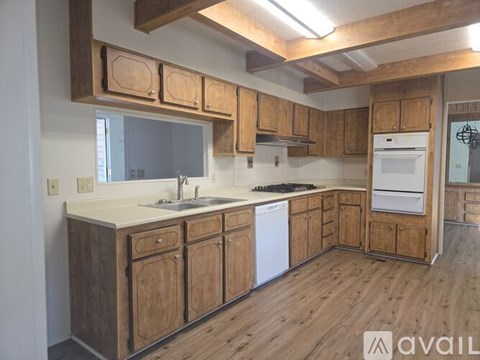 A kitchen with wooden cabinets and a white countertop.