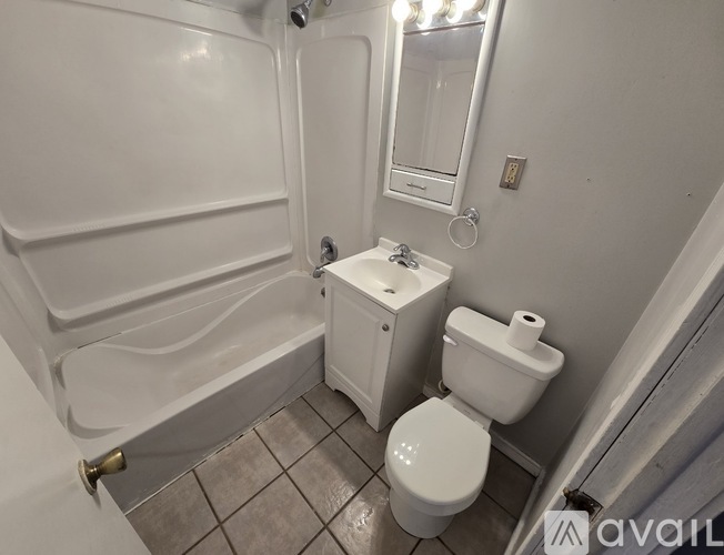 A white toilet and sink in a small bathroom.
