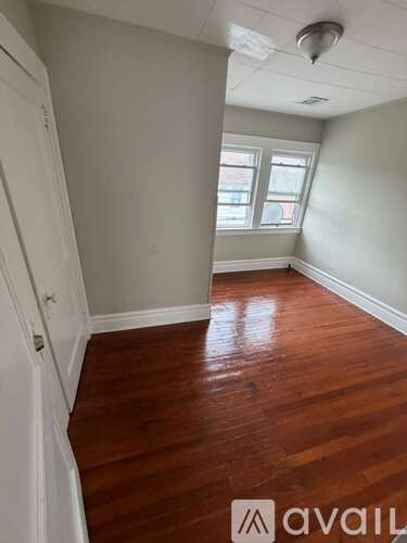 A room with wooden floors and a window.
