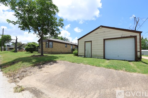 A two-story house with a garage door is for sale.