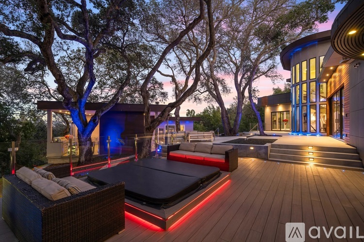 A modern house with a pool and a hot tub.