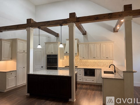 A bedroom with a bed, dresser, and ceiling fan.