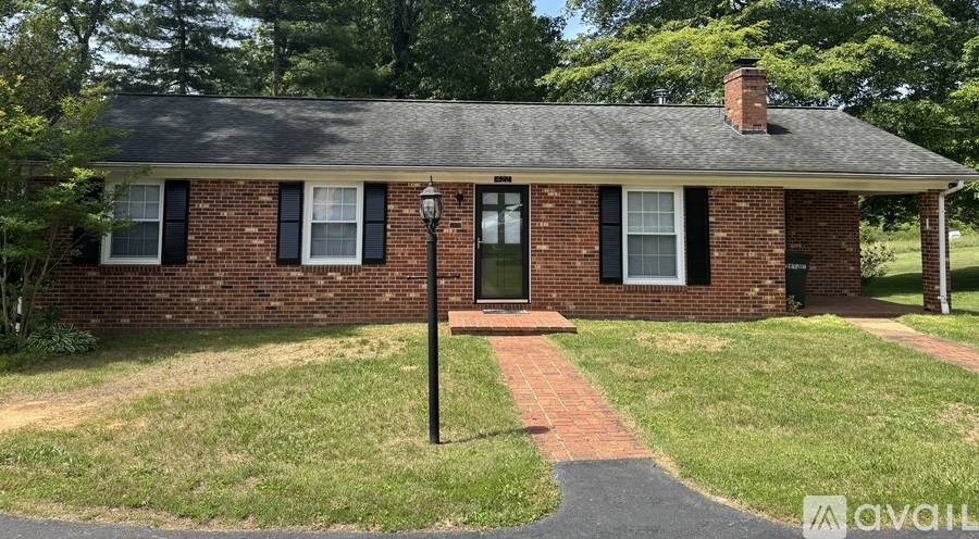 A small brick house with a black lamp post in front.