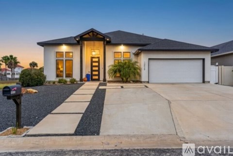 A house with a driveway and a mailbox in front.