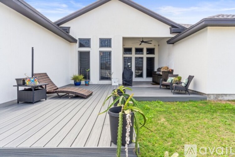 A house with a white exterior and a wooden deck.