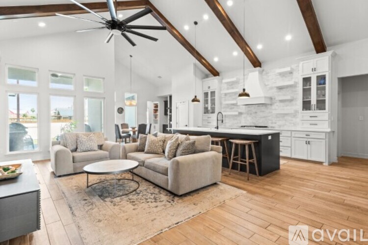 A spacious living room with a large couch and a fireplace.