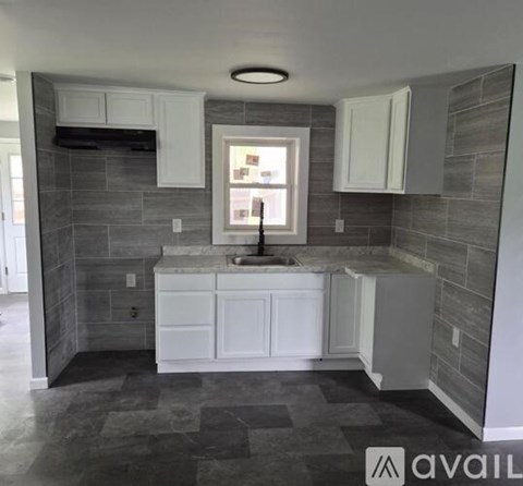A kitchen with a sink and cabinets.