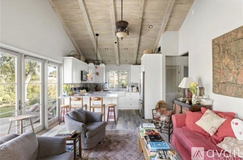 A living room with a grey couch and a red couch.