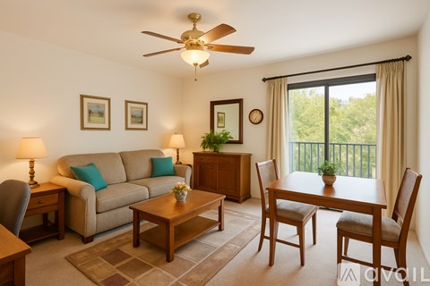 A living room with a couch, chairs, and a dining table.