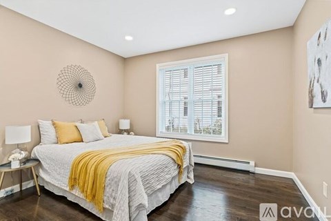 A bedroom with a bed covered in a yellow blanket.