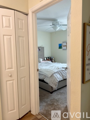 A bedroom with a bed, dresser, and mirror.