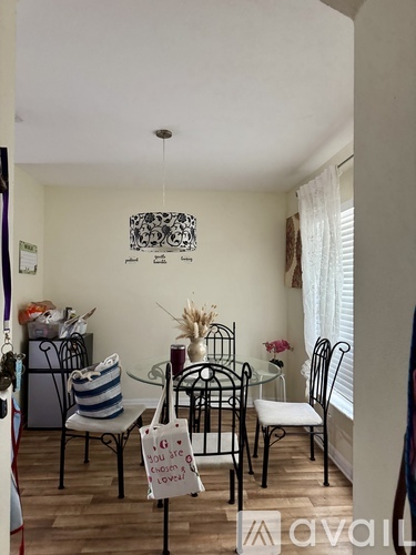 A dining room with a glass table and chairs.