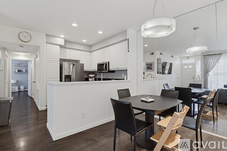 A modern kitchen with a dining table and chairs.