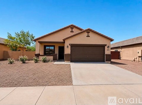 A house with a garage and driveway in front.