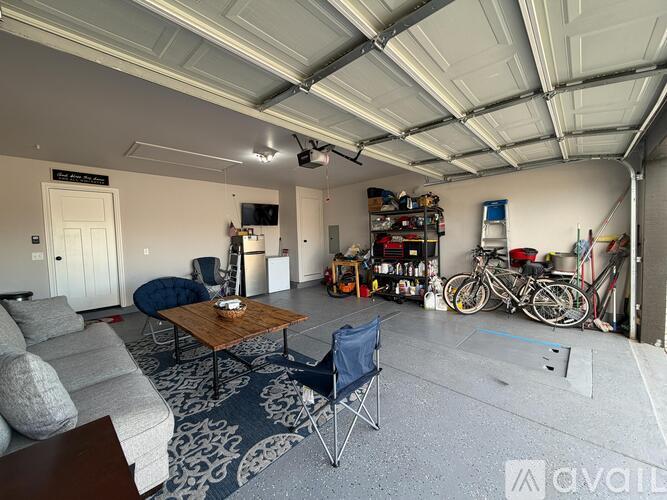 A spacious garage with a living area and a bicycle.
